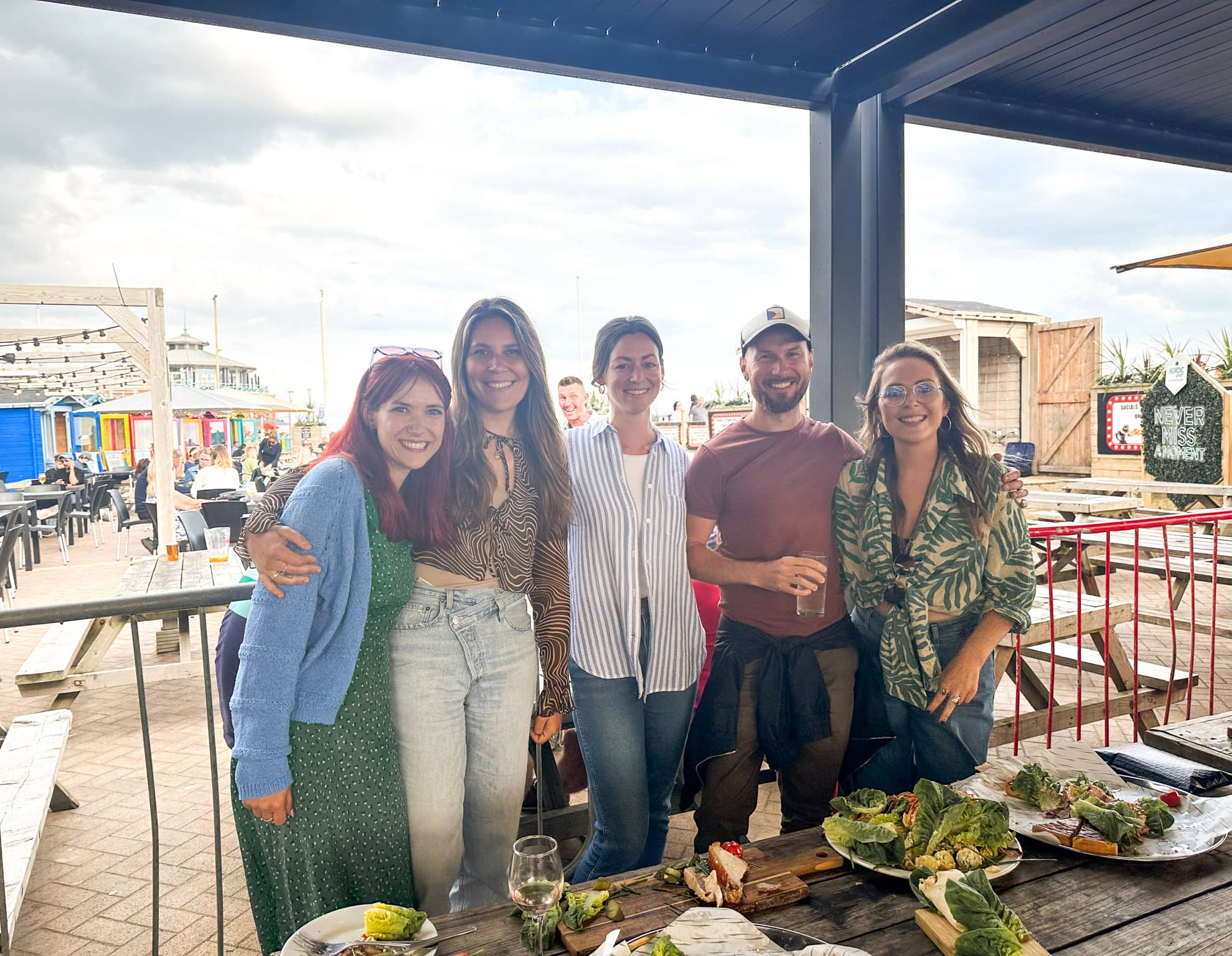 Smiling INSHUR employees enjoying their food at a team outing