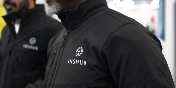 An INSHUR employee in a black branded jacket