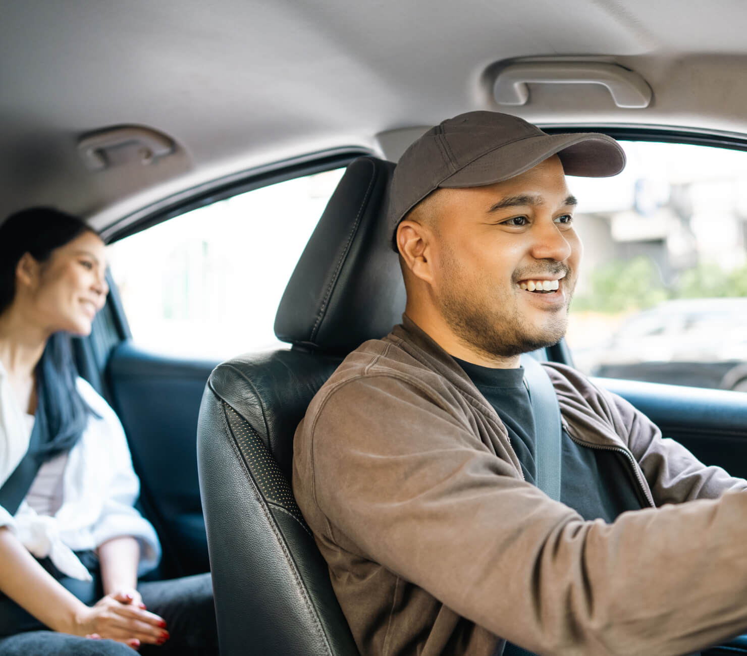 Happy taxi driver with a passenger