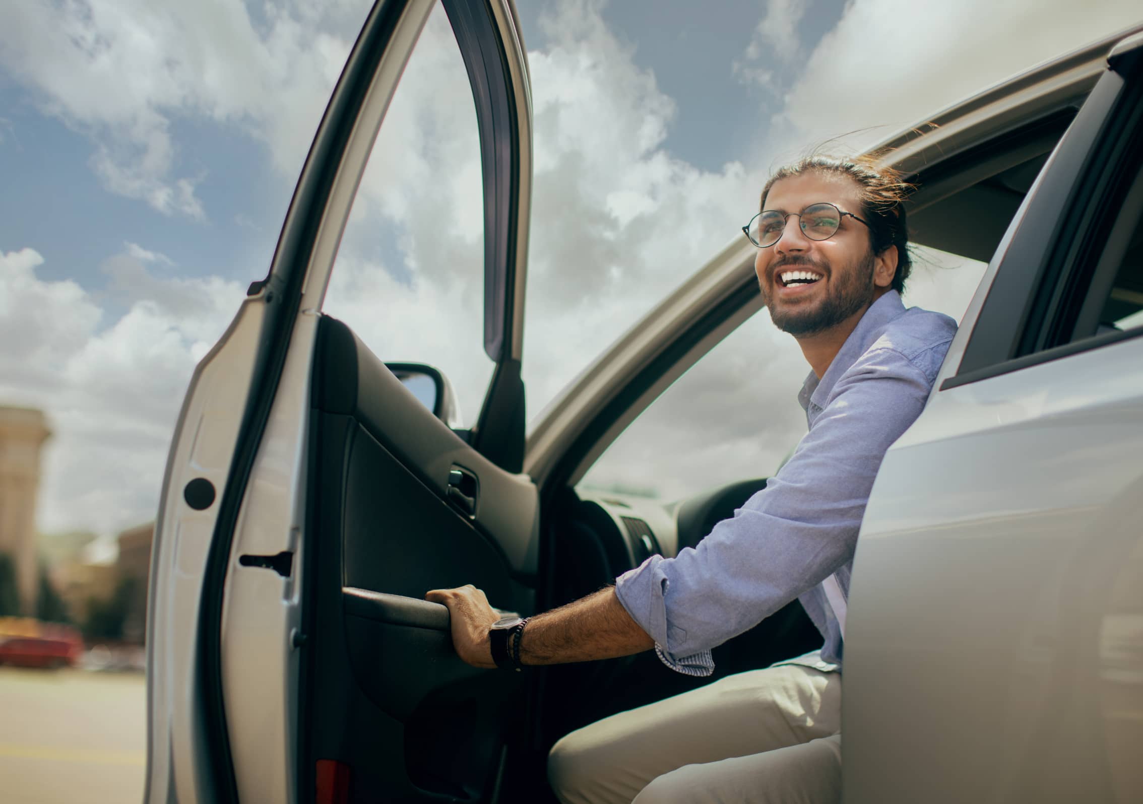 man smiling and getting ready to exit car