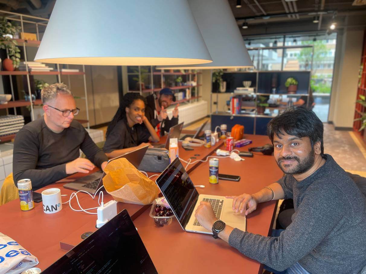 A group of smiling INSHUR employees working at their desks